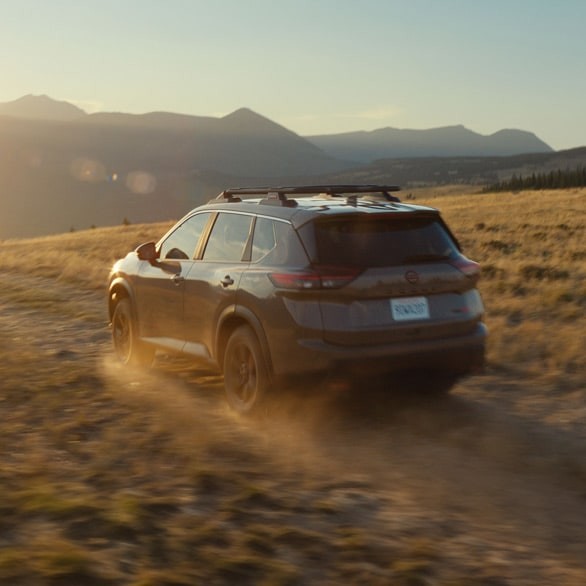 2026.5 Nissan Rogue Rock Creek SUV on a rugged trail with mountains in the distance