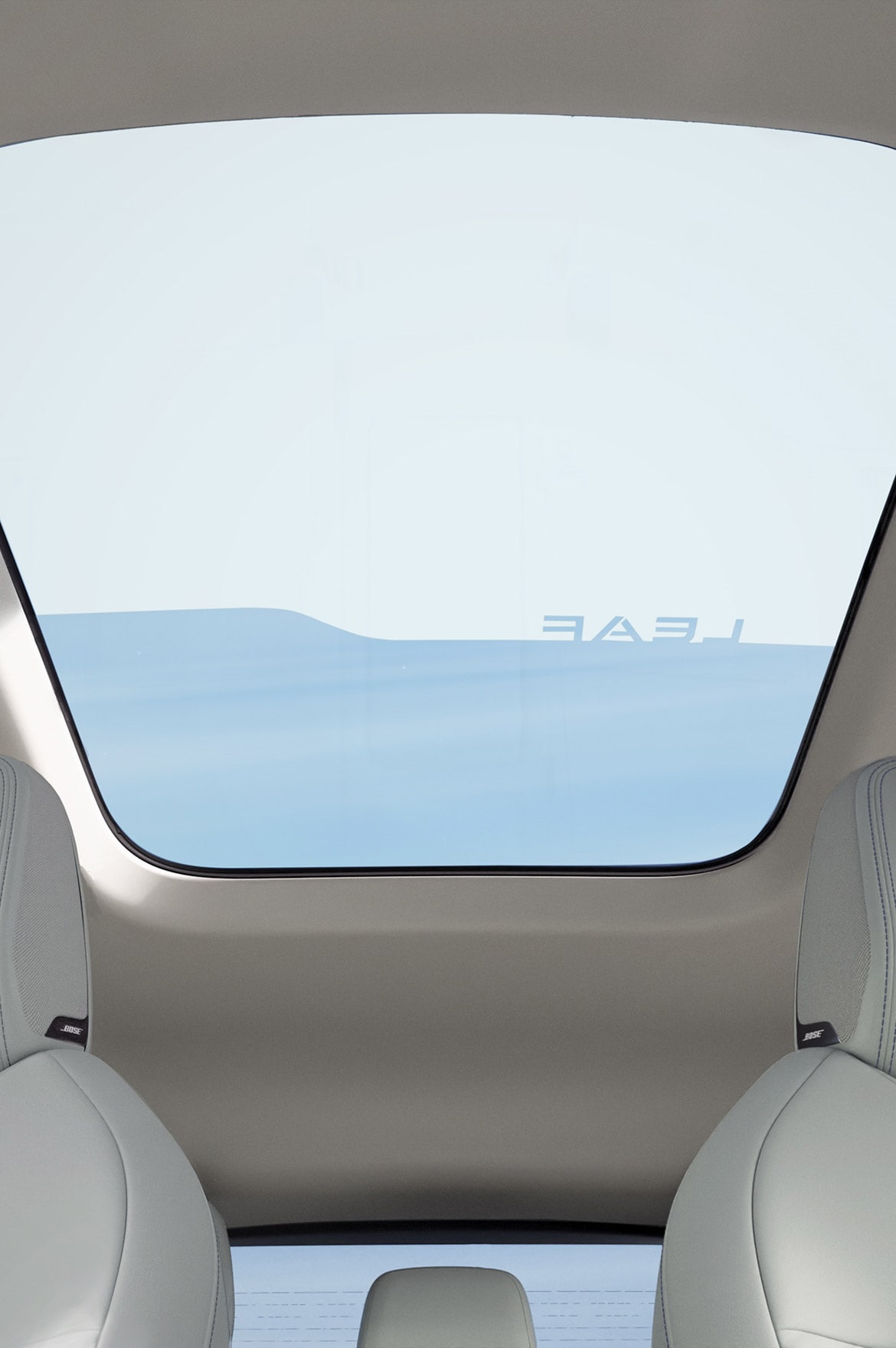 2026 Nissan LEAF interior view focusing on dimming panoramic with partial view of front and rear seats