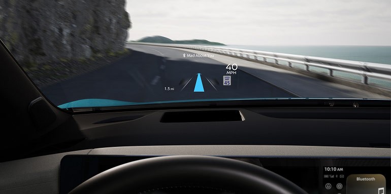 2026 Nissan Leaf view above steering wheel showing Head-Up Display on windshield