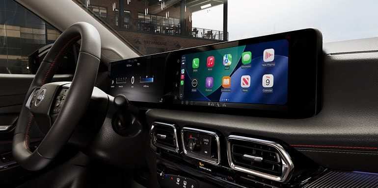 2027 Nissan Sentra interior view of 12.3 inch dual displays, steering wheel and dashboard.